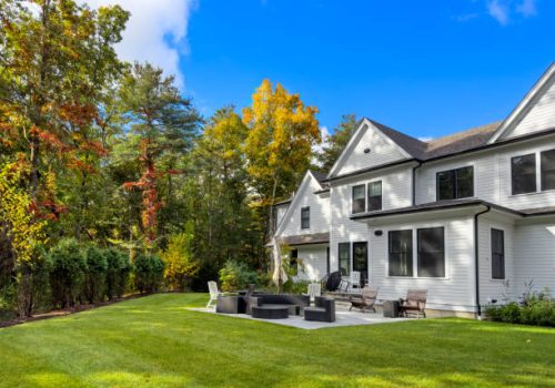 Patio cushions are put away and the table is sideways to drain water - summer in the suburban garden is history for this year and the leaves are getting colorful